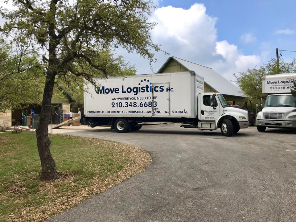 Image of moving company trucks parked in front of a residential client