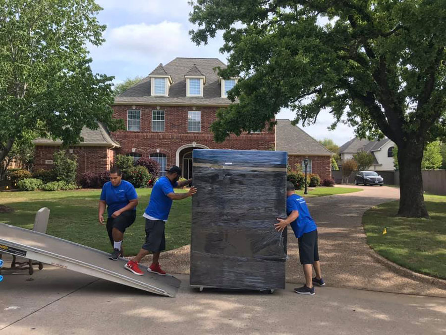 Image of Move Logistics crew moving residential furniture outside a home