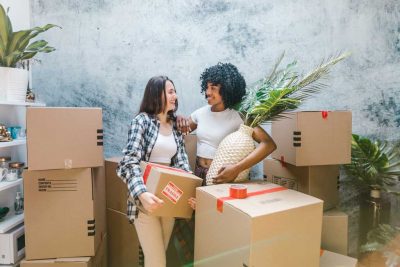 Image of two women moving boxes
