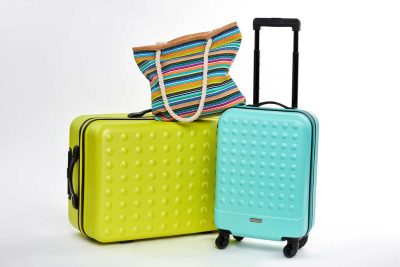 Image of two suitcases and a personal bag