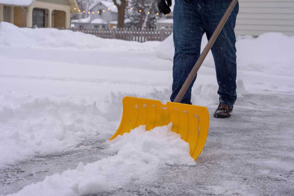 Image of a person shoveling snow from their driveway