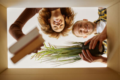 Couple packing belongings in a box for their move