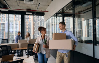 Office employees packing and moving boxes
