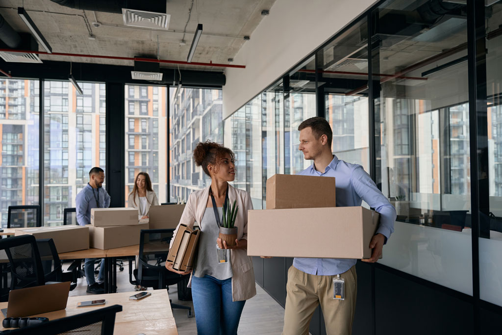 Office employees packing and moving boxes