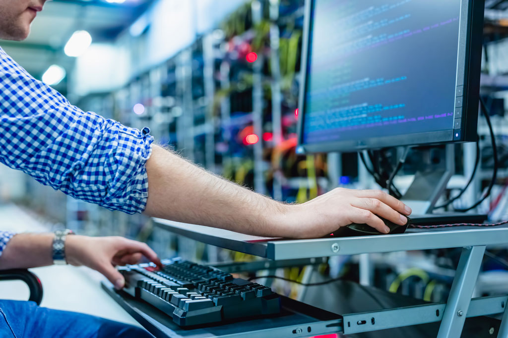 IT associate working in a computer server room