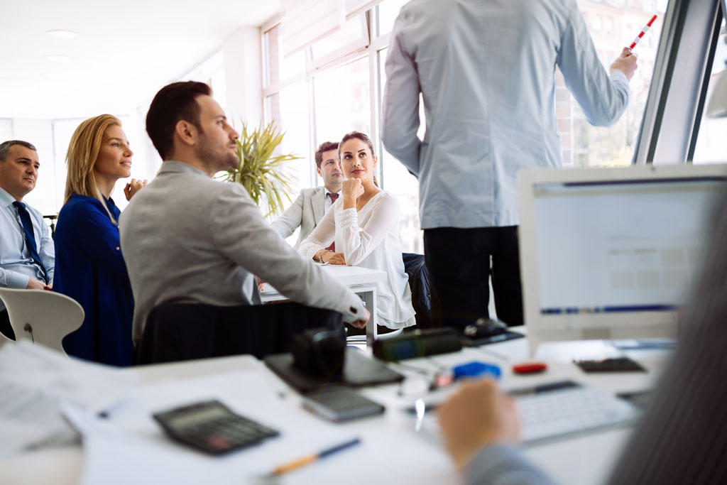 Business meeting discussing office relocation plan ahead of time